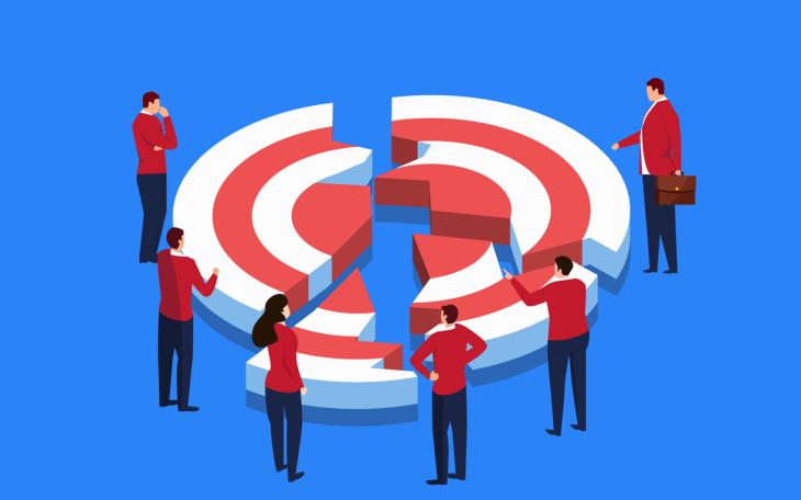 people stood around a broken target bulls eye
